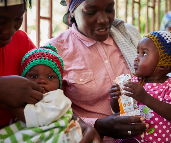 Mothers give their children treatment for malnutrition at an Action Against Hunger supported health center.