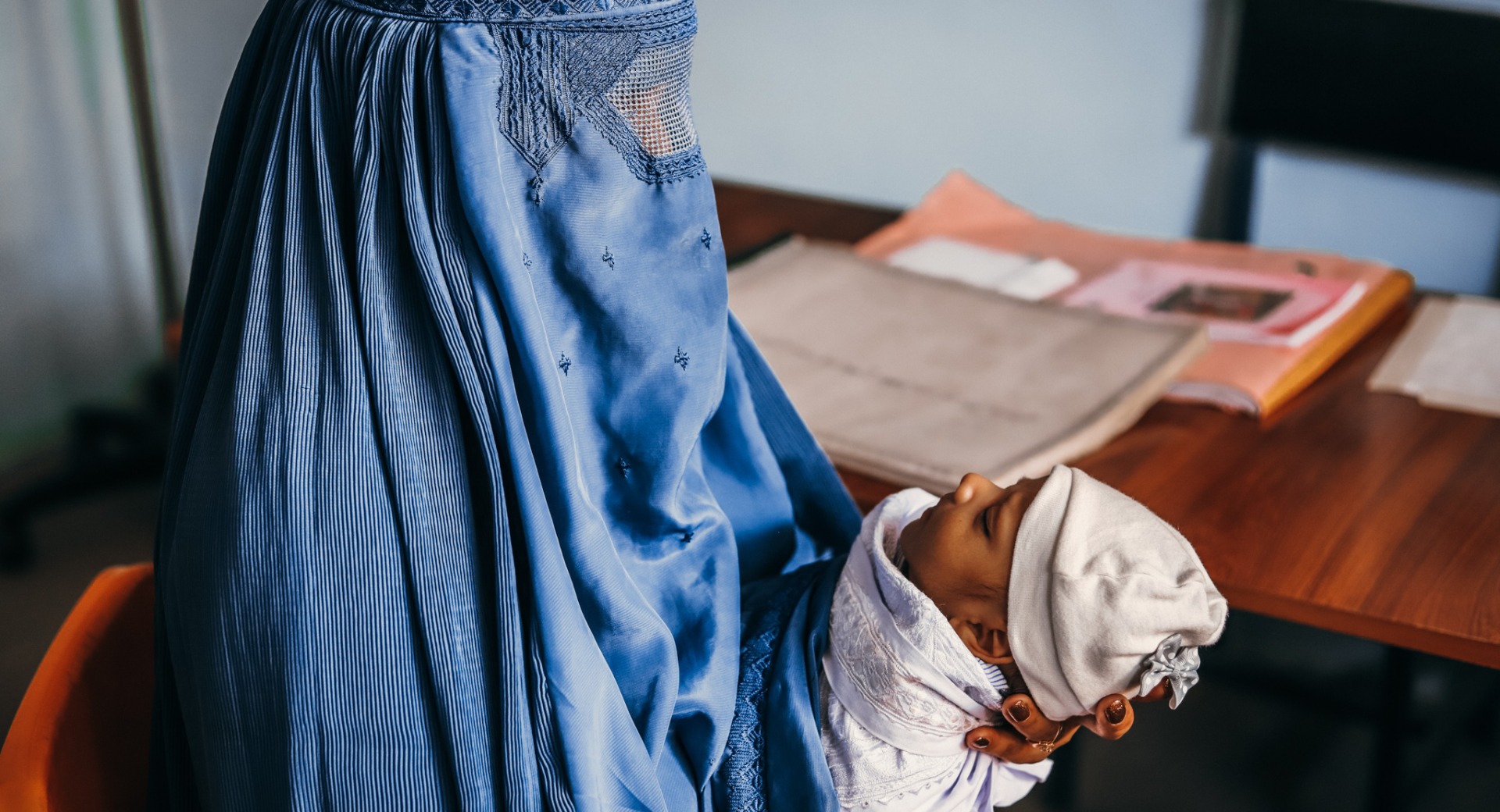 A mother learns about post-natal care during a medical consultation. (Parwan province, October 2020)