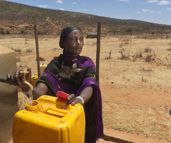 Loko fetches water from an Action Against Hunger water station.