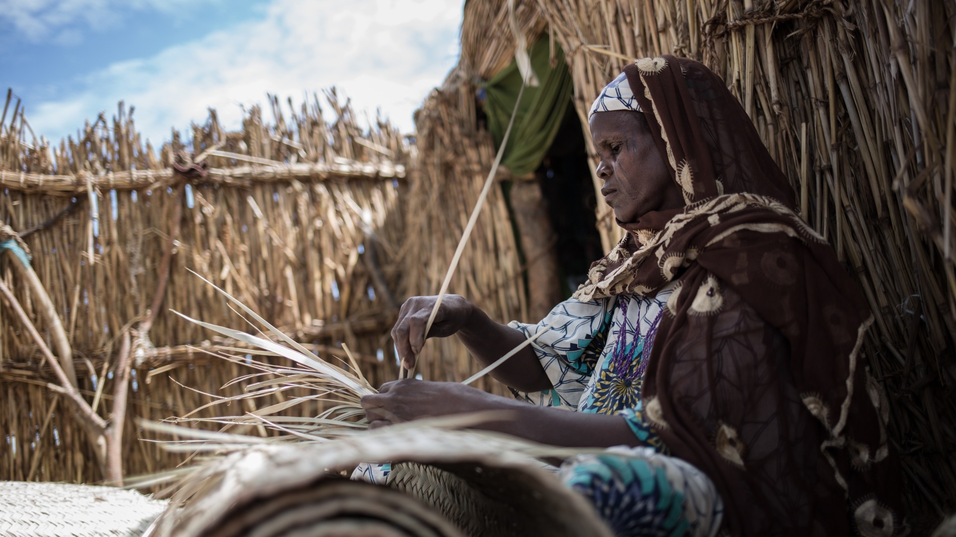 A woman weaves baskets in Niger.
