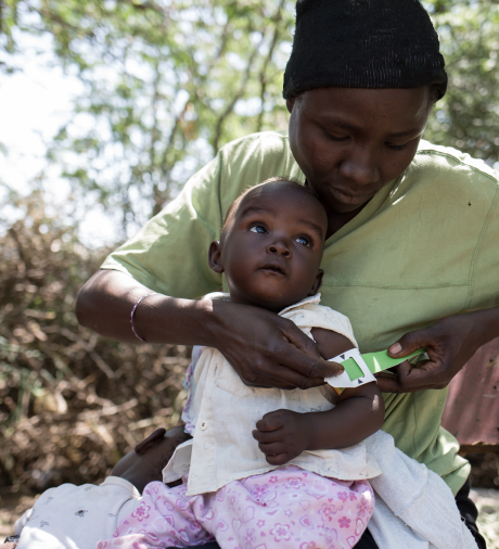 Elisabeth measures her daughter's nutrition status using a simple tool called the Mid-Upper Arm Circumference (MUAC) band